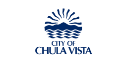 Flag of the City of Chula Vista, featuring a dark blue emblem of a sun rising over mountains and waves, with the text "CITY OF CHULA VISTA" below.