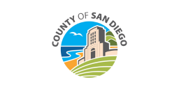 Flag of the County of San Diego, featuring a circular emblem with a building, coastline, and hills, and the words "COUNTY OF SAN DIEGO" in an arc.